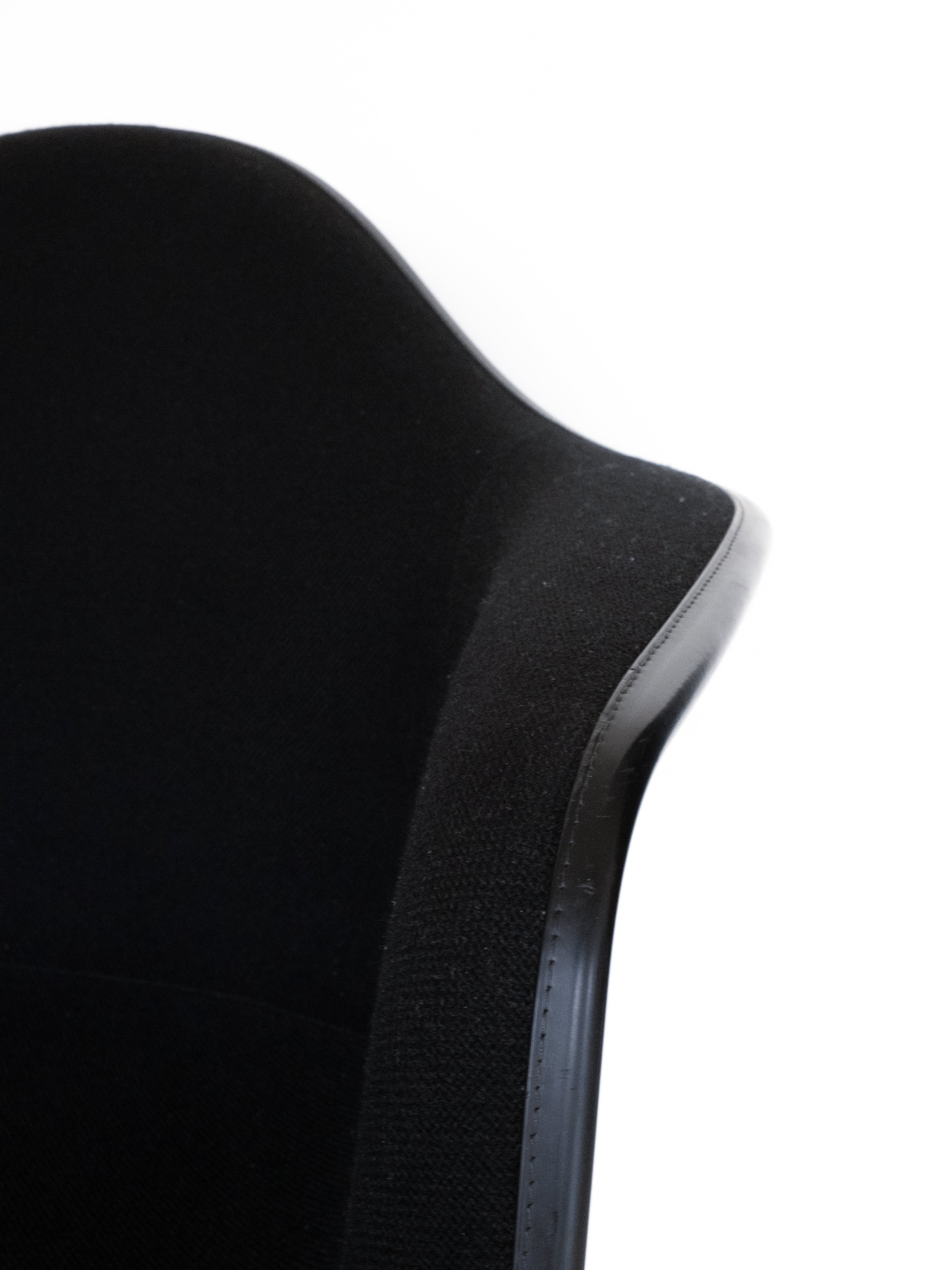 Black upholstered chair with sleek design by Vitra