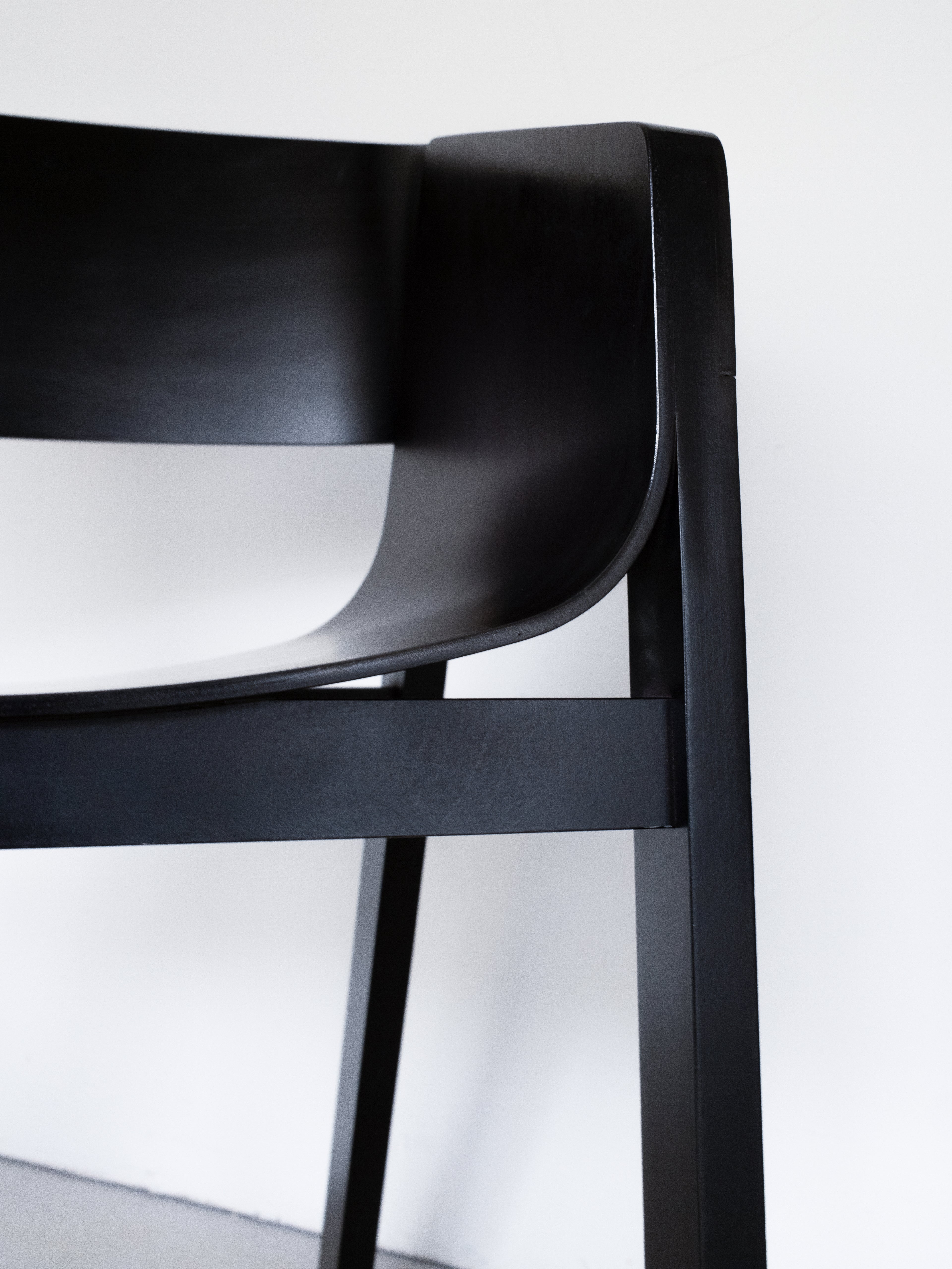 Merano Armchair seat and armrest detail, 100% beech wood, black stained, sleek design, minimalist aesthetic