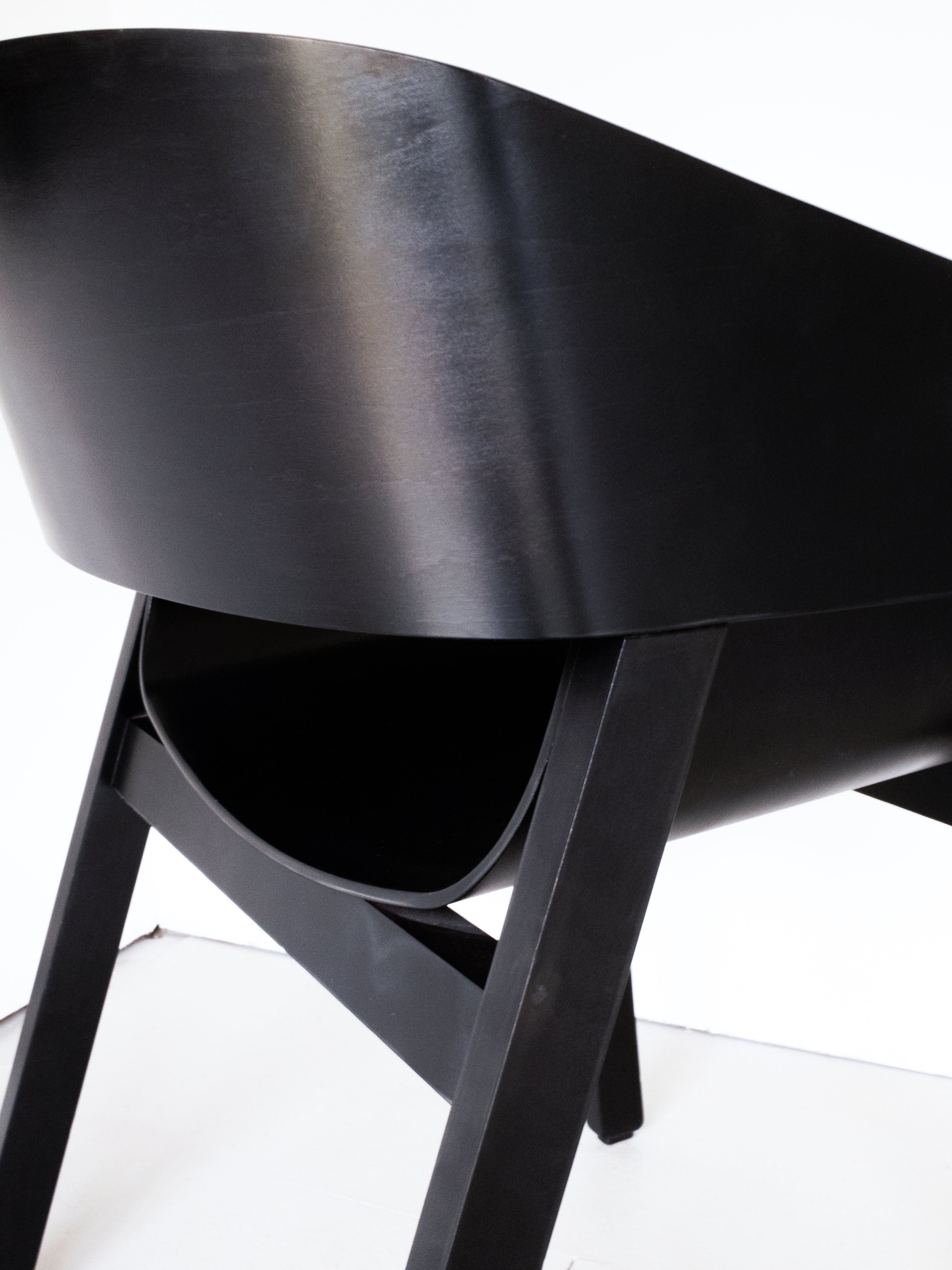 Merano Armchair seat and backrest detail, 100% beech wood, black stained, sleek design with curved backrest and angled legs