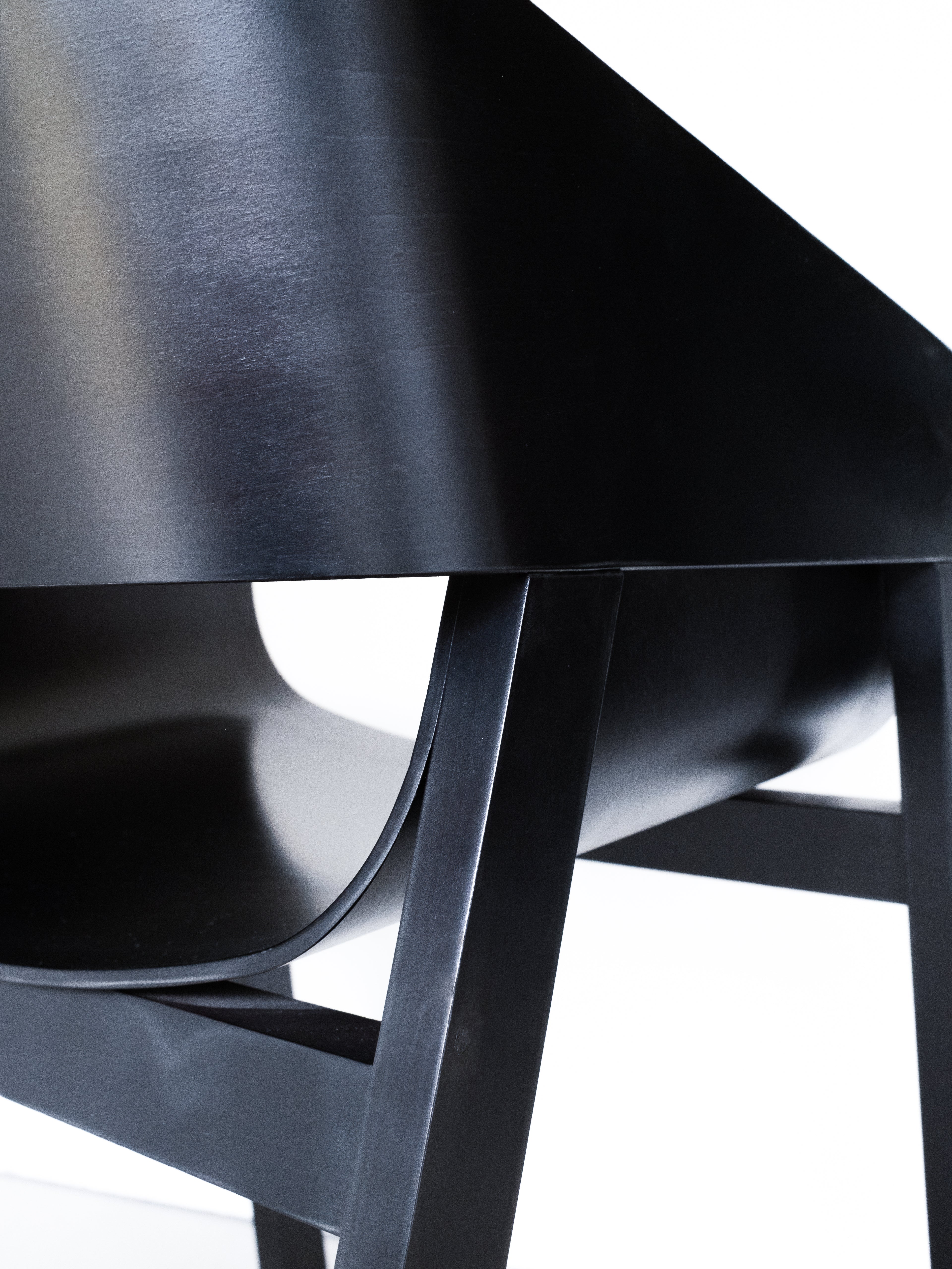 Merano Armchair seat and backrest detail, 100% beech wood, black stained, sleek design with curved seat and angled legs