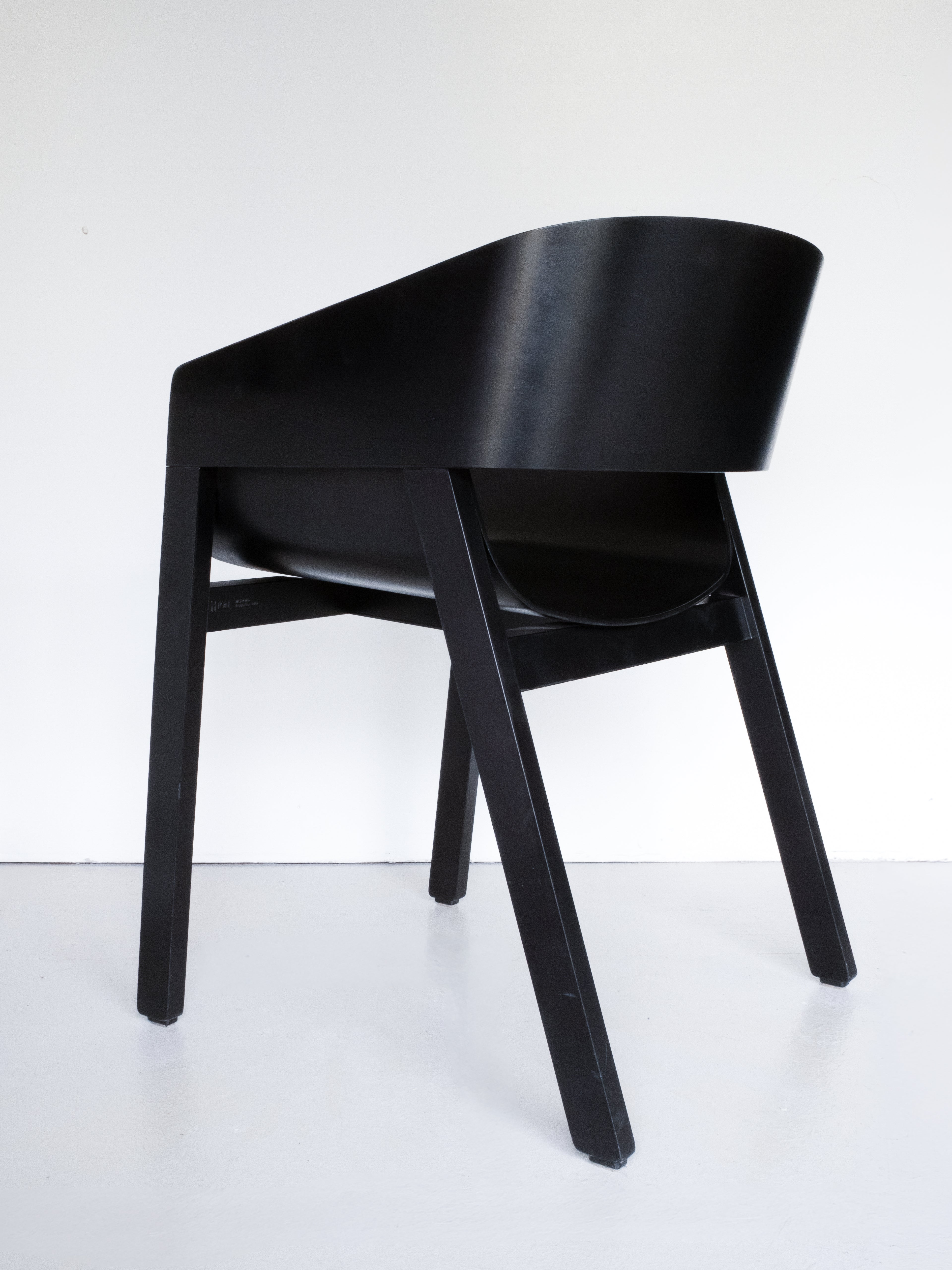 Ton Merano Armchair by Alexander Gufler, black stained beech, back view, curved backrest and angled legs, sleek design, minimalist aesthetic